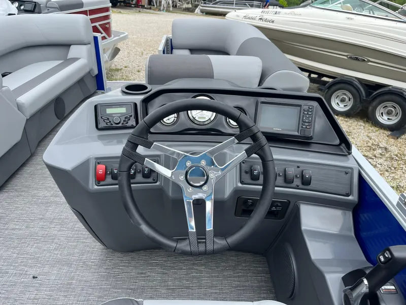 Slide: The Image of 2024 Bennington 188 SVL boat dashboard with steering wheel and control panel. - 7