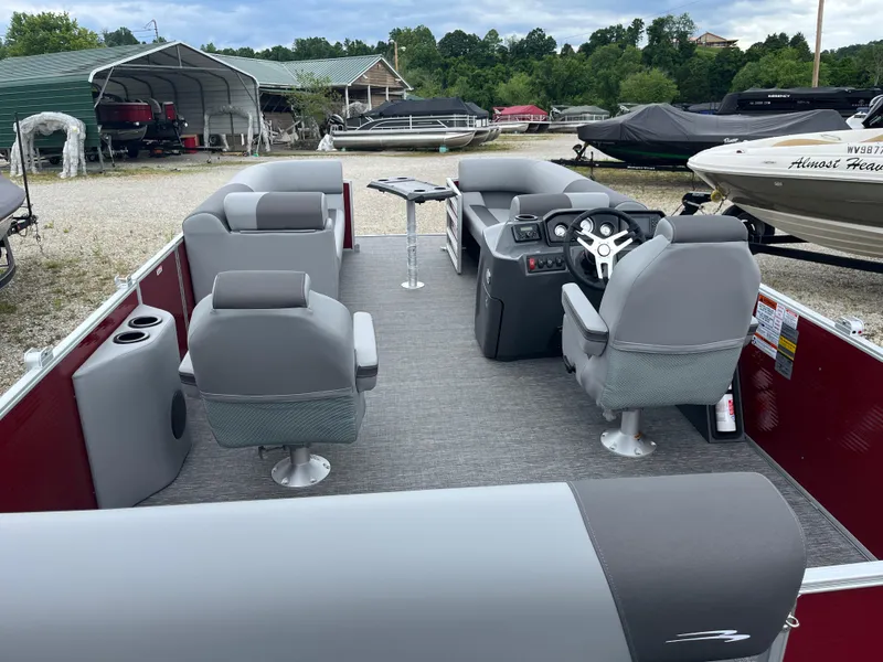 Slide: The Image of 2024 Bennington 20 SVSR pontoon boat interior with gray seating and steering console. - 11