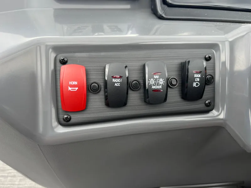 Slide: The Image of Control panel of 2024 Bennington 20 SVSR boat with horn, radio, navigation, and dock lights switches. - 16