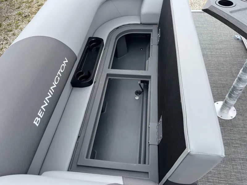 Slide: The Image of 2024 Bennington 20 SVSR boat with open storage compartment and cup holders. - 18