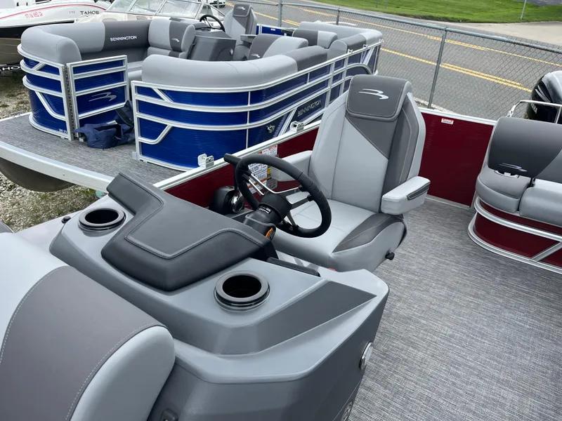 Slide: The Image of 2024 Bennington 20 SVSR pontoon boat interior with steering console and seating. - 7
