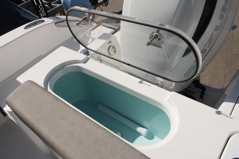 Slide: The Image of 2024 Sea Pro 240 boat livewell with transparent lid and cushioned seating. - 11