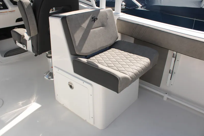 Slide: The Image of 2024 Sea Pro 240 boat interior with cushioned seating and storage compartment. - 13