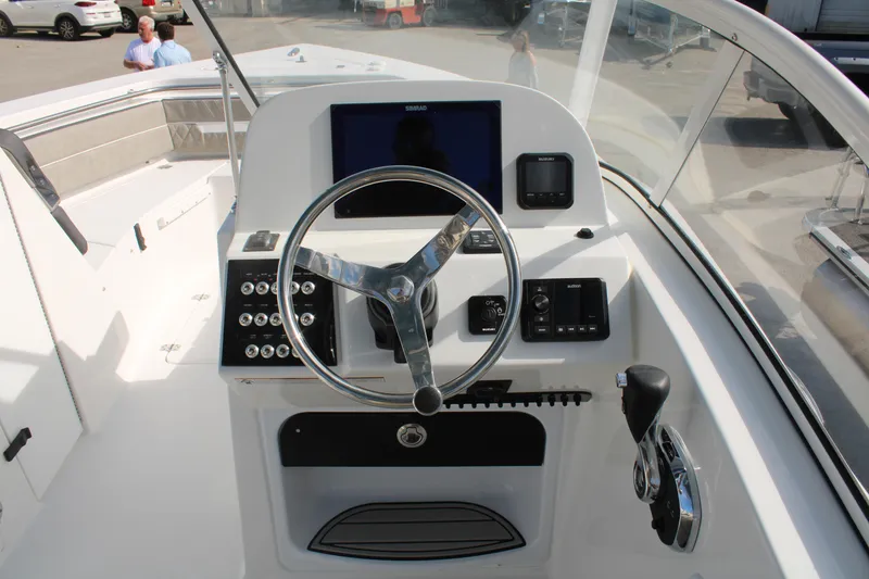 Slide: The Image of 2024 Sea Pro 240 boat helm with modern controls and navigation system. - 19