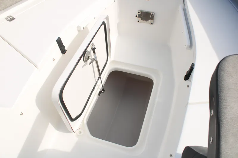 Slide: The Image of 2024 Sea Pro 240 boat storage compartment with open hatch. - 23
