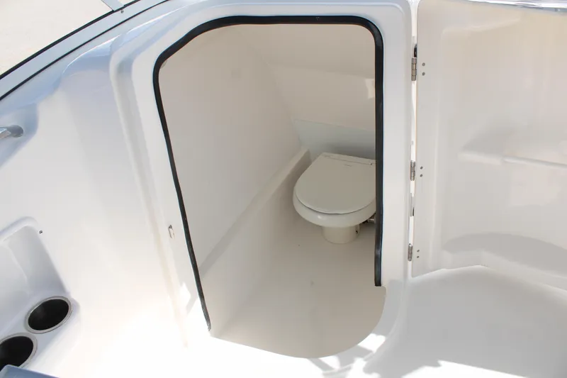 Slide: The Image of 2024 Sea Pro 240 boat interior with a compact marine toilet. - 24