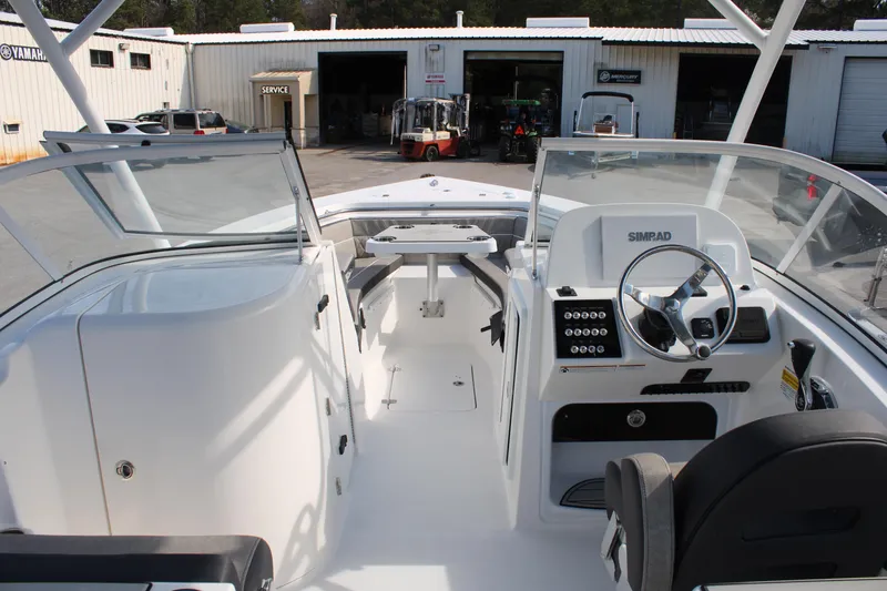 Slide: The Image of 2024 Sea Pro 240 boat interior with steering console and seating. - 30