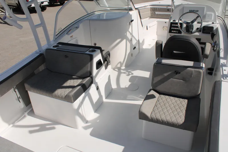 Slide: The Image of 2024 Sea Pro 240 boat interior with cushioned seating and steering console. - 5