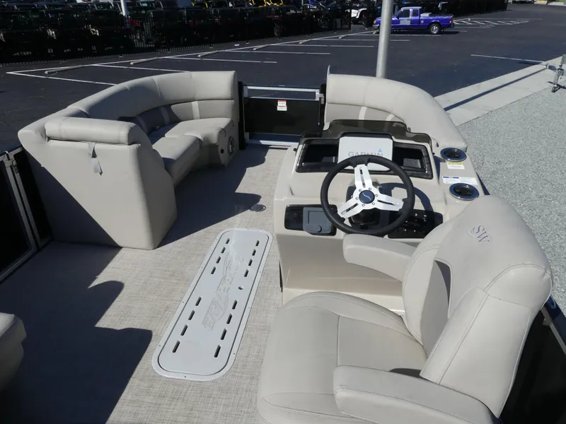 Slide: The Image of 2023 Silver Wave 2410 SW3 RLP pontoon boat interior with plush seating and modern helm. - 7