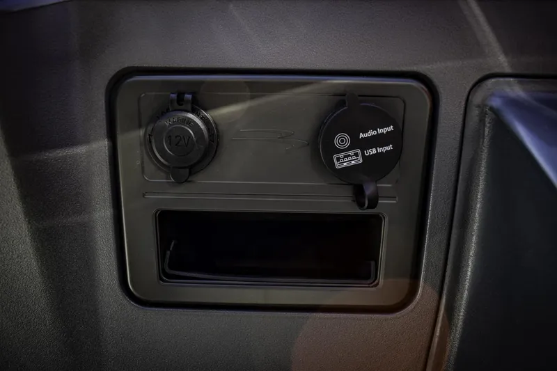 Slide: The Image of 2024 Bennington 22 SVSB dashboard with 12V power outlet and USB/audio input. - 19