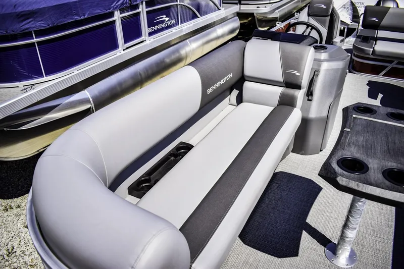 Slide: The Image of 2024 Bennington 22 SVSB pontoon boat interior with plush seating and cup holders. - 5
