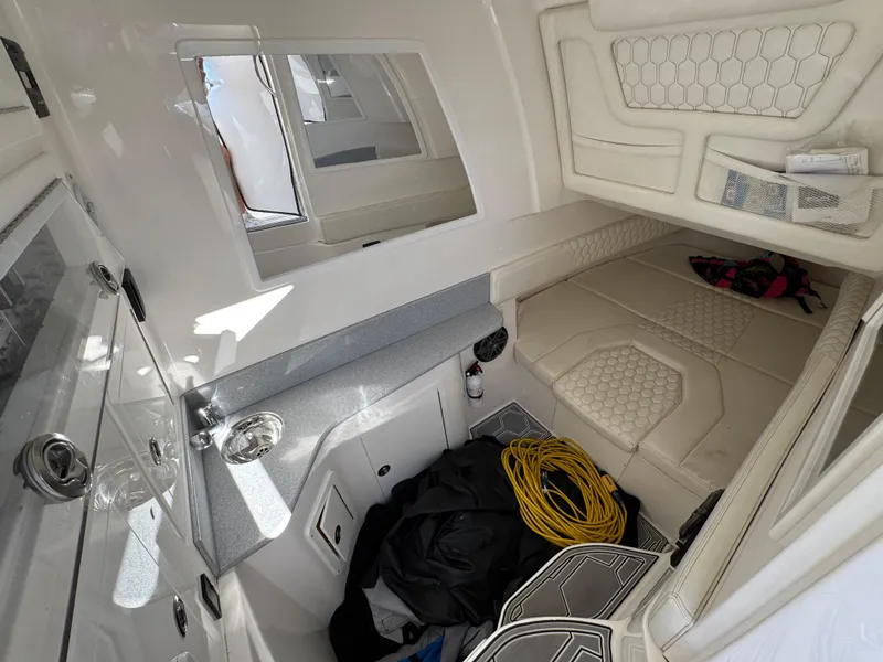 Slide: The Image of Interior of a 2019 Blackwater 43SF boat, featuring a compact cabin with seating and storage. - 23