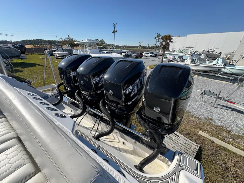 Slide: The Image of Four powerful outboard motors on a 2019 Blackwater 43SF boat, parked outdoors. - 36