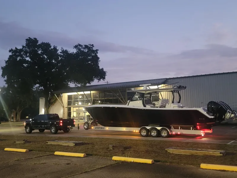 Slide: The Image of Blackwater 43SF boat on trailer, parked outside a building at dusk, 2019 model. - 39