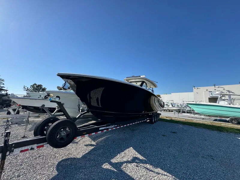 Slide: The Image of 2019 Blackwater 43SF boat on trailer, parked outdoors under clear blue sky. - 6