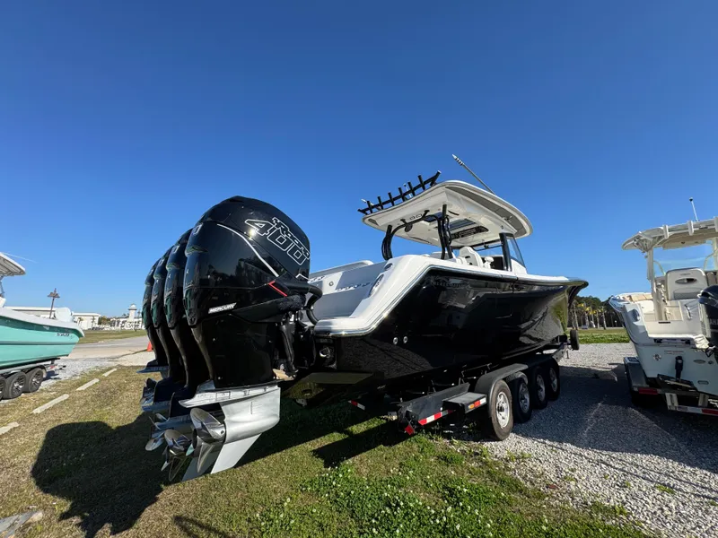 Slide: The Image of 2019 Blackwater 43SF boat with triple outboard engines on a trailer, under clear blue sky. - 9