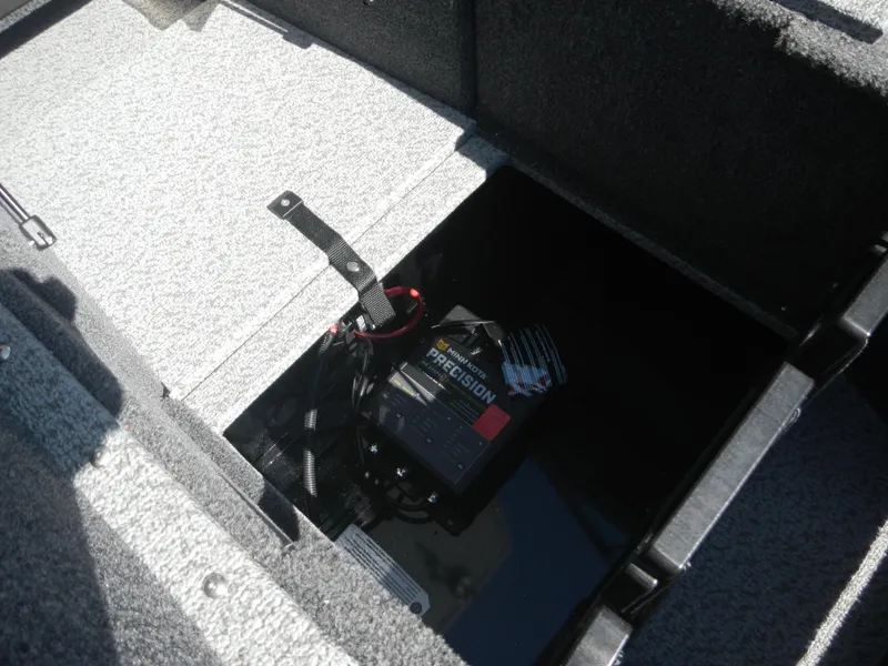 Slide: The Image of 2024 Lund 1875 Impact XS Sport boat battery compartment with Precision charger. - 11
