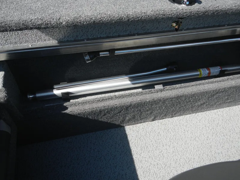 Slide: The Image of 2024 Lund 1875 Impact XS Sport storage compartment with fishing rod holder. - 2