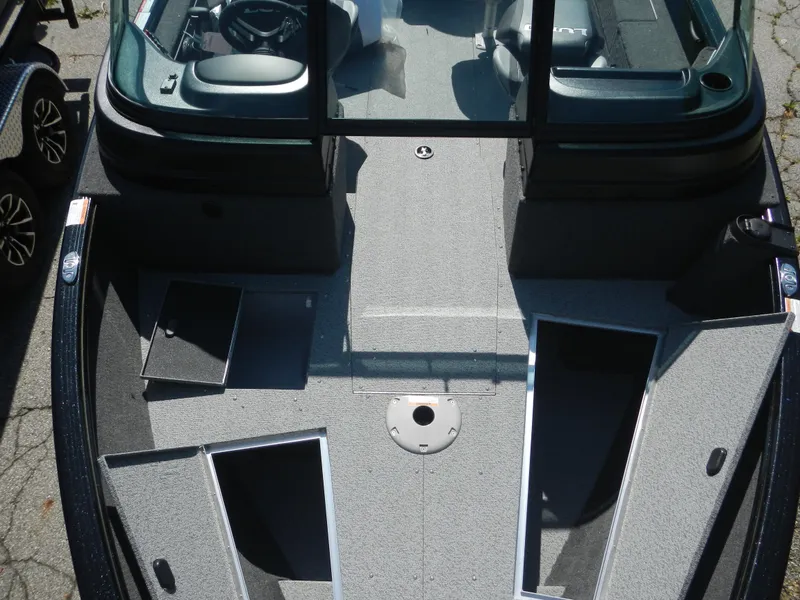 Slide: The Image of 2024 Lund 1875 Impact XS Sport boat interior with open storage compartments. - 5