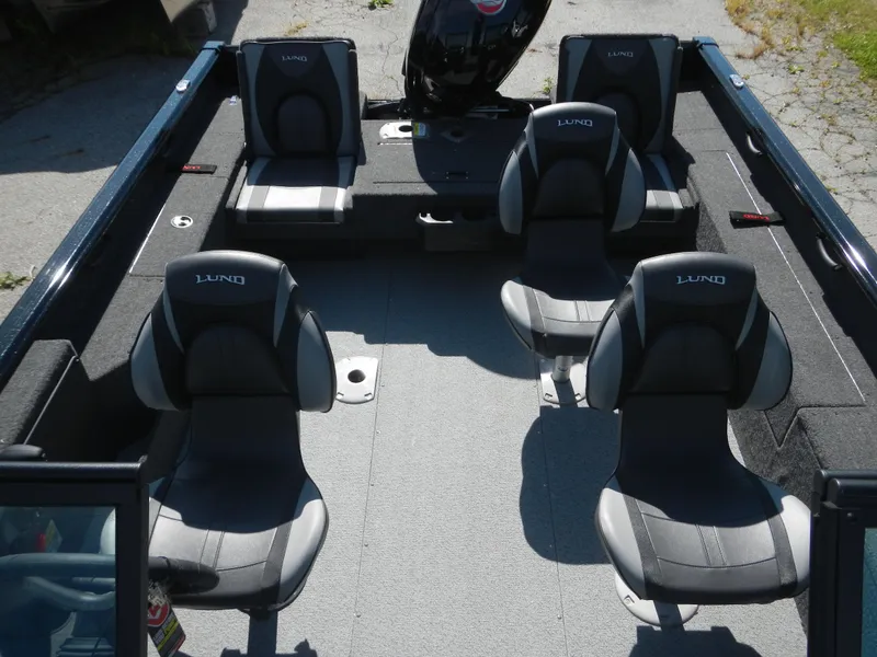 Slide: The Image of 2024 Lund 1875 Impact XS Sport boat interior with four seats and motor. - 6