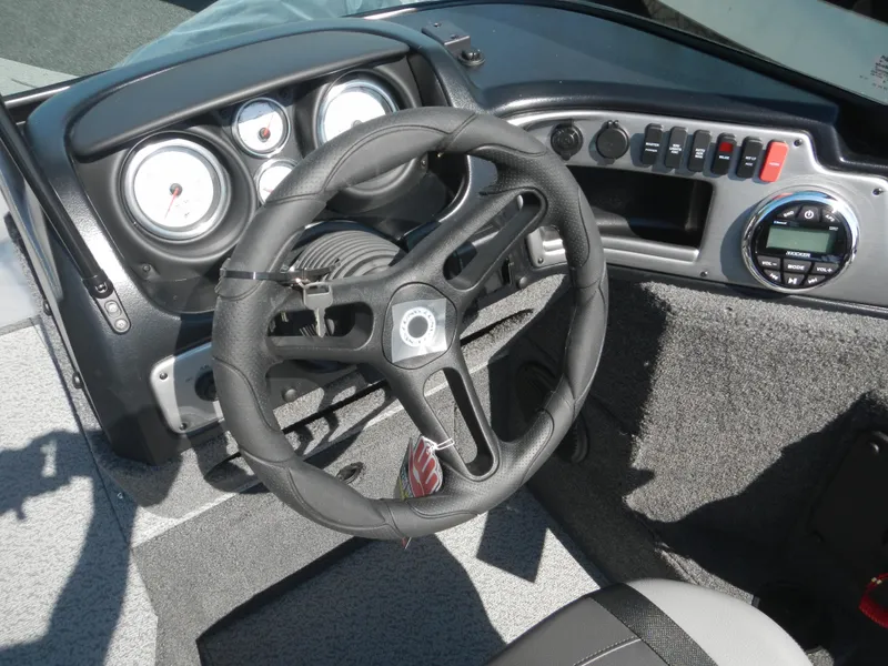 Slide: The Image of 2024 Lund 1875 Impact XS Sport boat dashboard and steering wheel. - 7