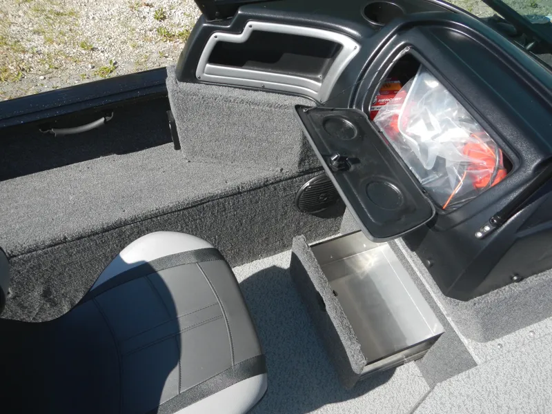 Slide: The Image of 2024 Lund 1875 Impact XS Sport boat interior with storage compartments and seating. - 8