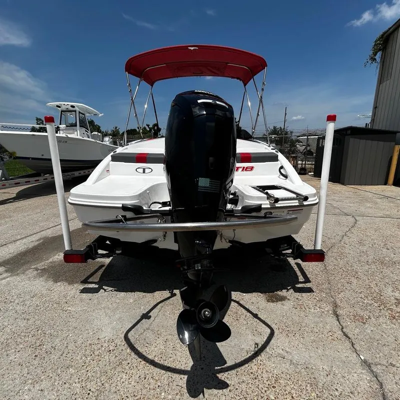 Slide: The Image of 2022 Tahoe T18 boat with outboard motor and red canopy, rear view. - 10