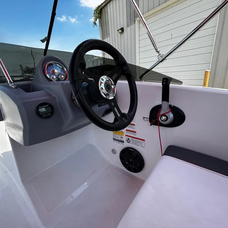 Slide: The Image of 2022 Tahoe T18 boat cockpit with steering wheel and control panel. - 14