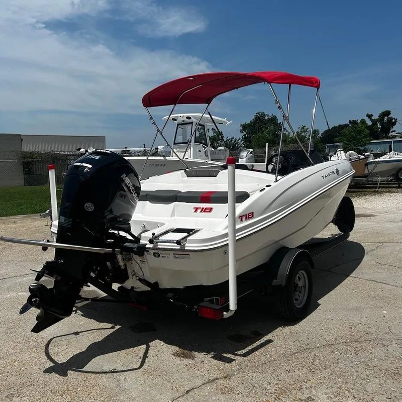 Slide: The Image of 2022 Tahoe T18 boat with red canopy and outboard motor on trailer. - 5