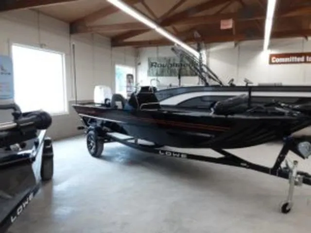 Slide: The Image of 2023 Lowe RX1860 boat displayed in a showroom. - 3