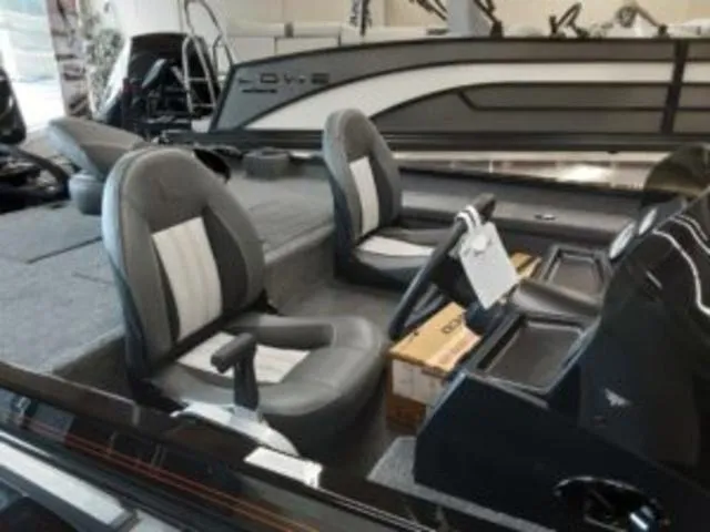 Slide: The Image of 2023 Lowe RX1860 boat interior with dual seats and steering console. - 6