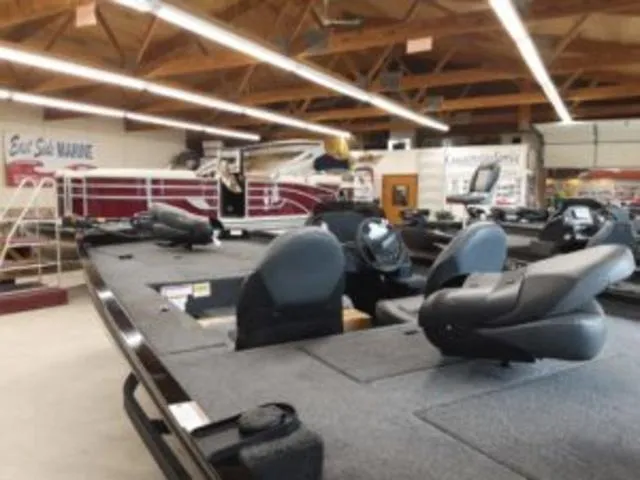 Slide: The Image of 2023 Lowe RX1860 boat on display in a showroom. - 7