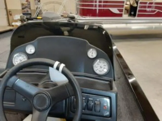 Slide: The Image of 2023 Lowe RX1860 boat dashboard with steering wheel and gauges. - 9