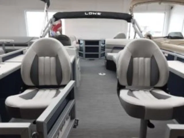 Slide: The Image of 2023 Lowe SF194 boat interior with cushioned seats and canopy. - 12