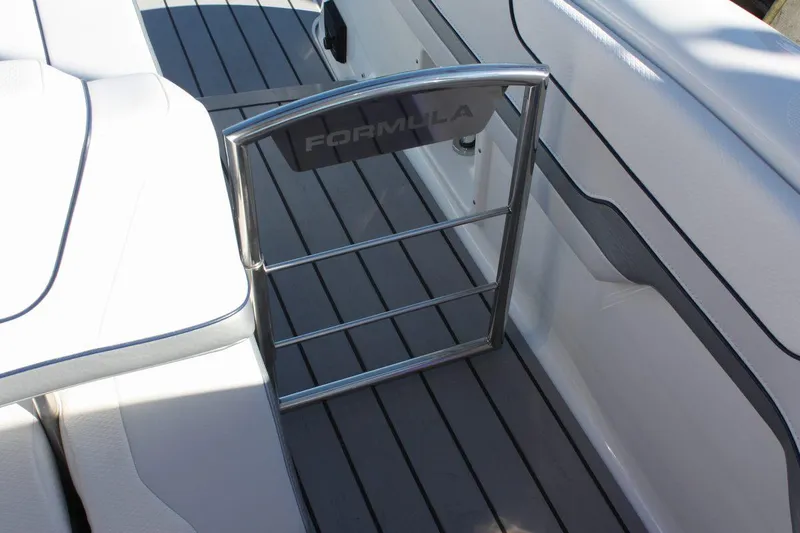 Slide: The Image of 2025 Formula 350 Sun Sport boat interior with stainless steel gate and white seating. - 11