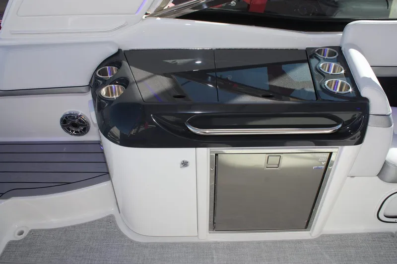 Slide: The Image of 2025 Formula 350 Sun Sport boat interior with sleek kitchenette and stainless steel fridge. - 18