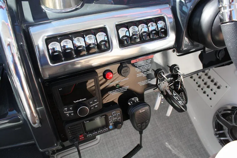 Slide: The Image of Control panel of the 2025 Formula 350 Sun Sport boat with various switches and communication devices. - 33