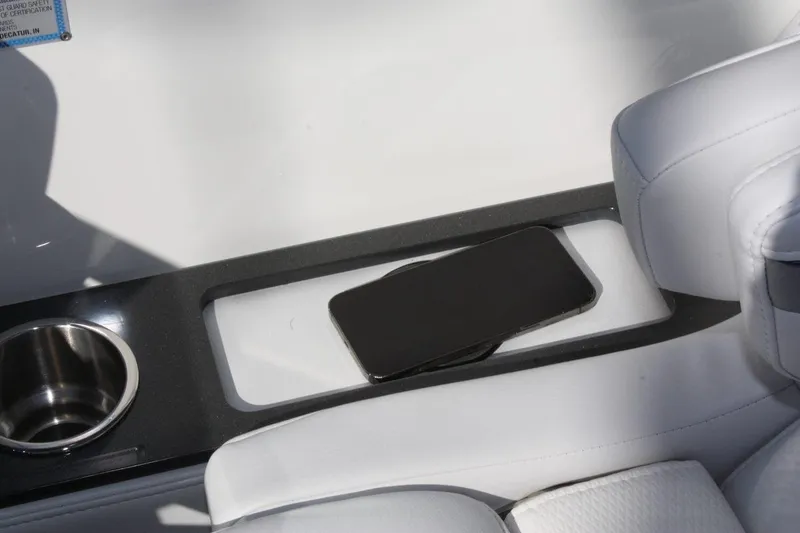 Slide: The Image of Smartphone resting on the console of a 2025 Formula 350 Sun Sport boat. - 34