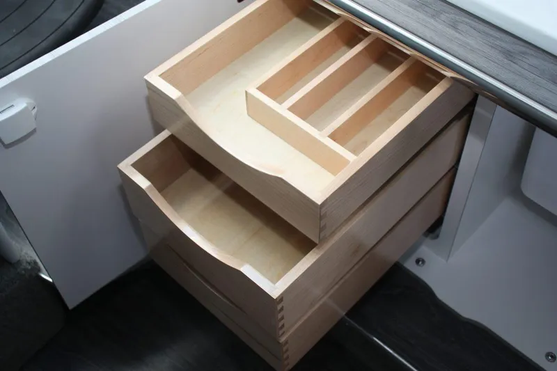 Slide: The Image of Wooden drawers in the 2025 Formula 350 Sun Sport boat's interior. - 48