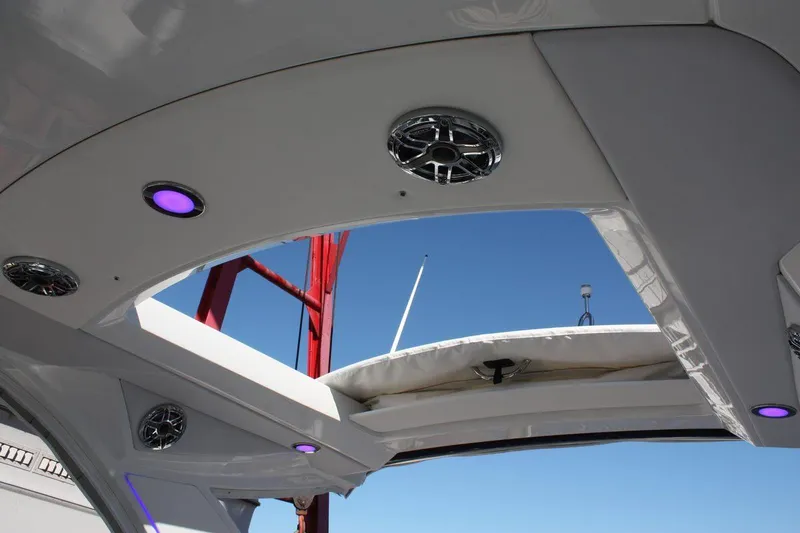 Slide: The Image of 2025 Formula 350 Sun Sport boat interior with purple LED lights and speakers. - 8