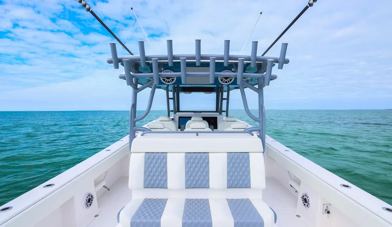 Slide: The Image of 2024 Invincible 46 Catamaran on open sea, showcasing spacious deck and seating. - 21