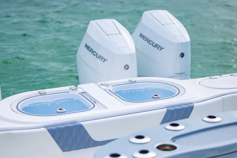 Slide: The Image of 2024 Invincible 46 Catamaran with dual Mercury engines on turquoise water. - 26