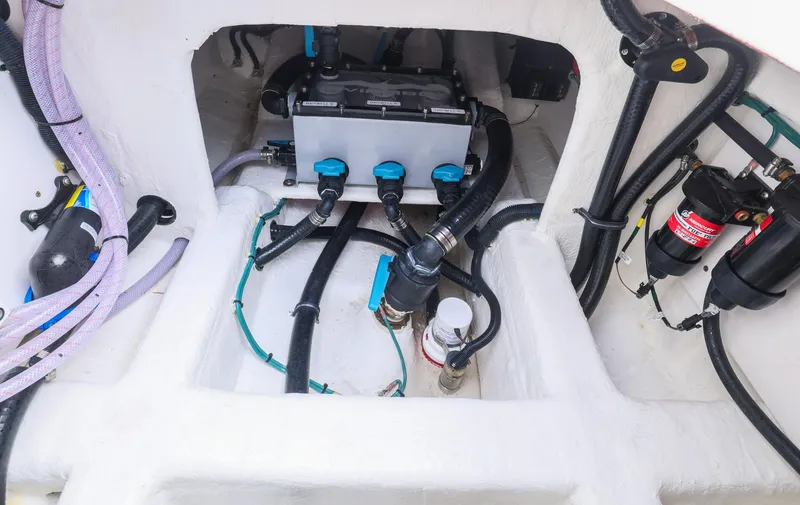 Slide: The Image of 2024 Invincible 46 Catamaran engine compartment with hoses and wiring. - 33