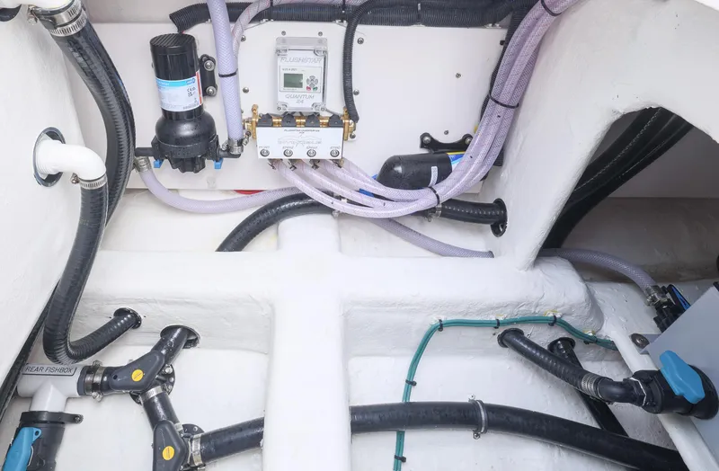 Slide: The Image of 2024 Invincible 46 Catamaran engine room with wiring and plumbing systems. - 34