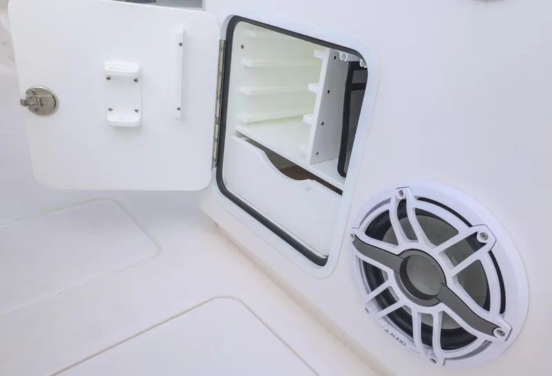 Slide: The Image of Open storage compartment and speaker on 2024 Invincible 46 Catamaran. - 35