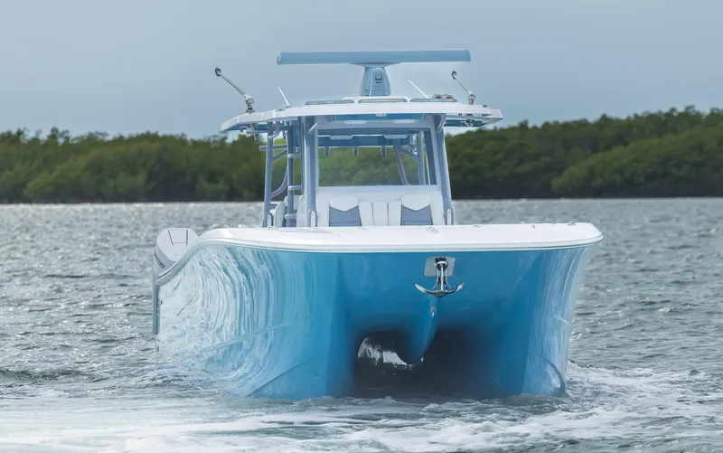 Slide: The Image of 2024 Invincible 46 Catamaran cruising on water, showcasing sleek design and vibrant blue hull. - 37