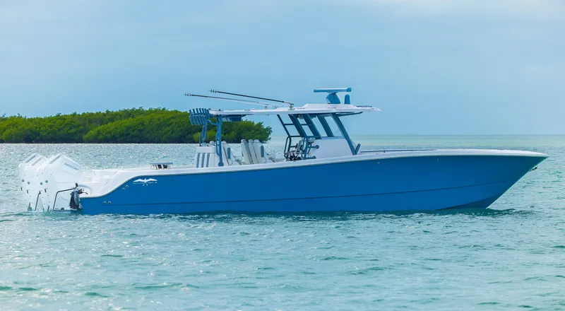 Slide: The Image of 2024 Invincible 46 Catamaran in blue, cruising on calm waters. - 39