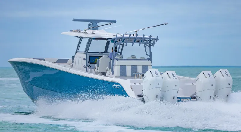 Slide: The Image of 2024 Invincible 46 Catamaran cruising on open water, showcasing powerful engines and sleek design. - 41