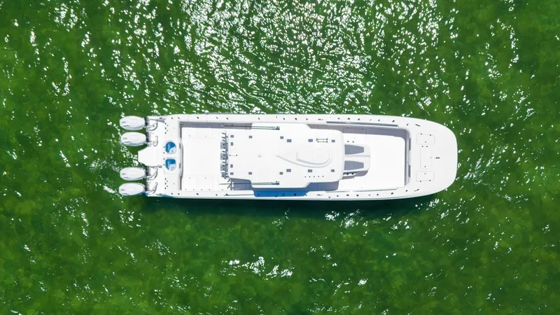 Slide: The Image of Aerial view of 2024 Invincible 46 Catamaran on vibrant green water. - 42
