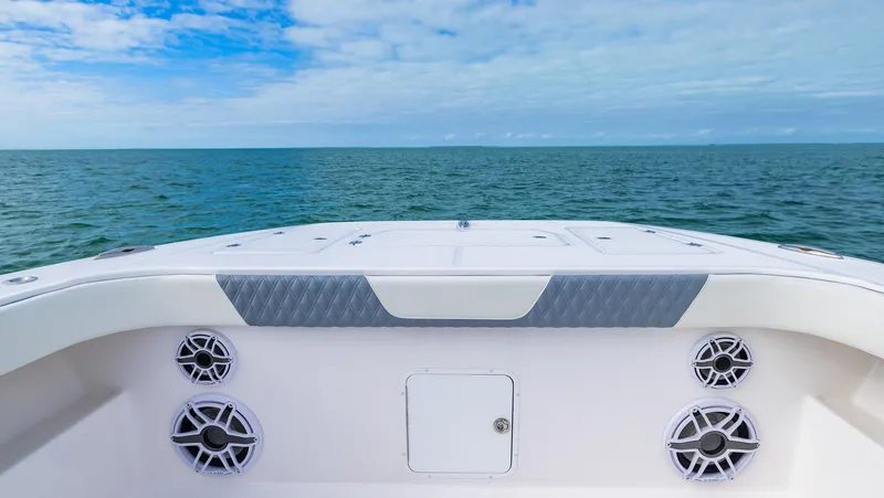 Slide: The Image of 2024 Invincible 46 Catamaran deck view with ocean backdrop and clear sky. - 7